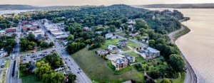Aerial view of downtown Guntersville, Alabama, with lakeside homes, wooded hills, and Lake Guntersville.