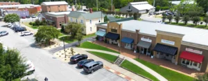 Aerial view of storefronts and tree-lined sidewalks in downtown Madison, Alabama.