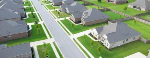 Aerial view of a Meridianville, Alabama, neighborhood with brick homes, green lawns, and sidewalks.