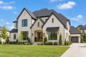 New construction home with white brick, stone accents, and fresh landscaping.