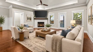 Virtually staged living room with neutral furnishings and a white brick fireplace.